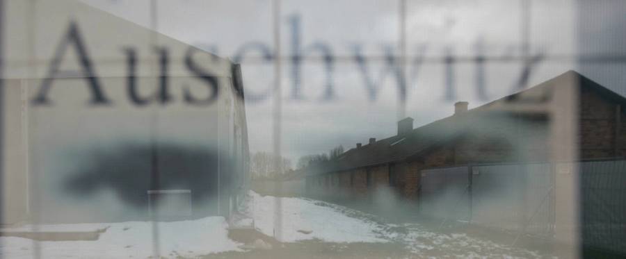 Barracks are seen through a poster at the former German nazi camp in Oswiecim (Auschwitz), Poland, on December 2, 2016.