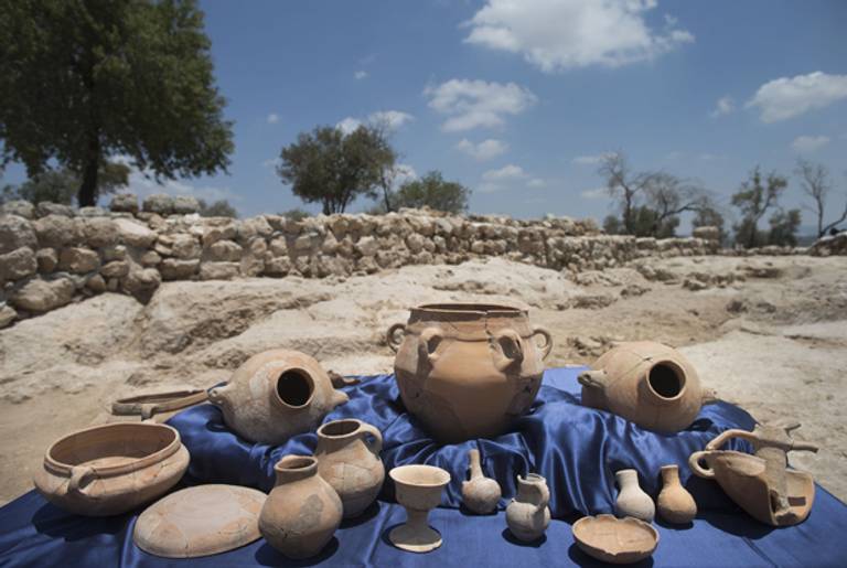 Archaeological excavation articles are displayed next to the remains of what is thought to be King David's palace, one of two royal public buildings that were found during archaeological excavation in what is believed to be the Kingdom of Judah of the tenth century BCE, on July 18, 2013 in Khirbet Qeiyafa, Israel. (Uriel Sinai/Getty Images)