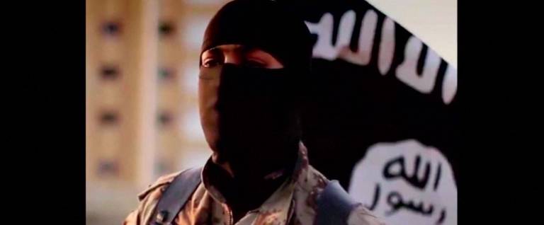 A masked man speaking in what is believed to be a North American accent in a video that Islamic State militants released in September 2014 is pictured in this still frame from video obtained by Reuters October 7, 2014. The FBI said on October 7, 2014 that it was seeking information on the man's identity, and issued an appeal for help in identifying individuals heading overseas to join militants in combat. 