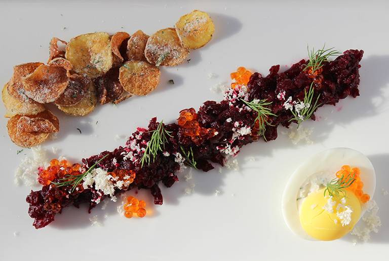 Beet tartar with salmon roe, egg, and sour cream and onion potato chips at Abe Fisher.(Courtesy of CookNSolo)