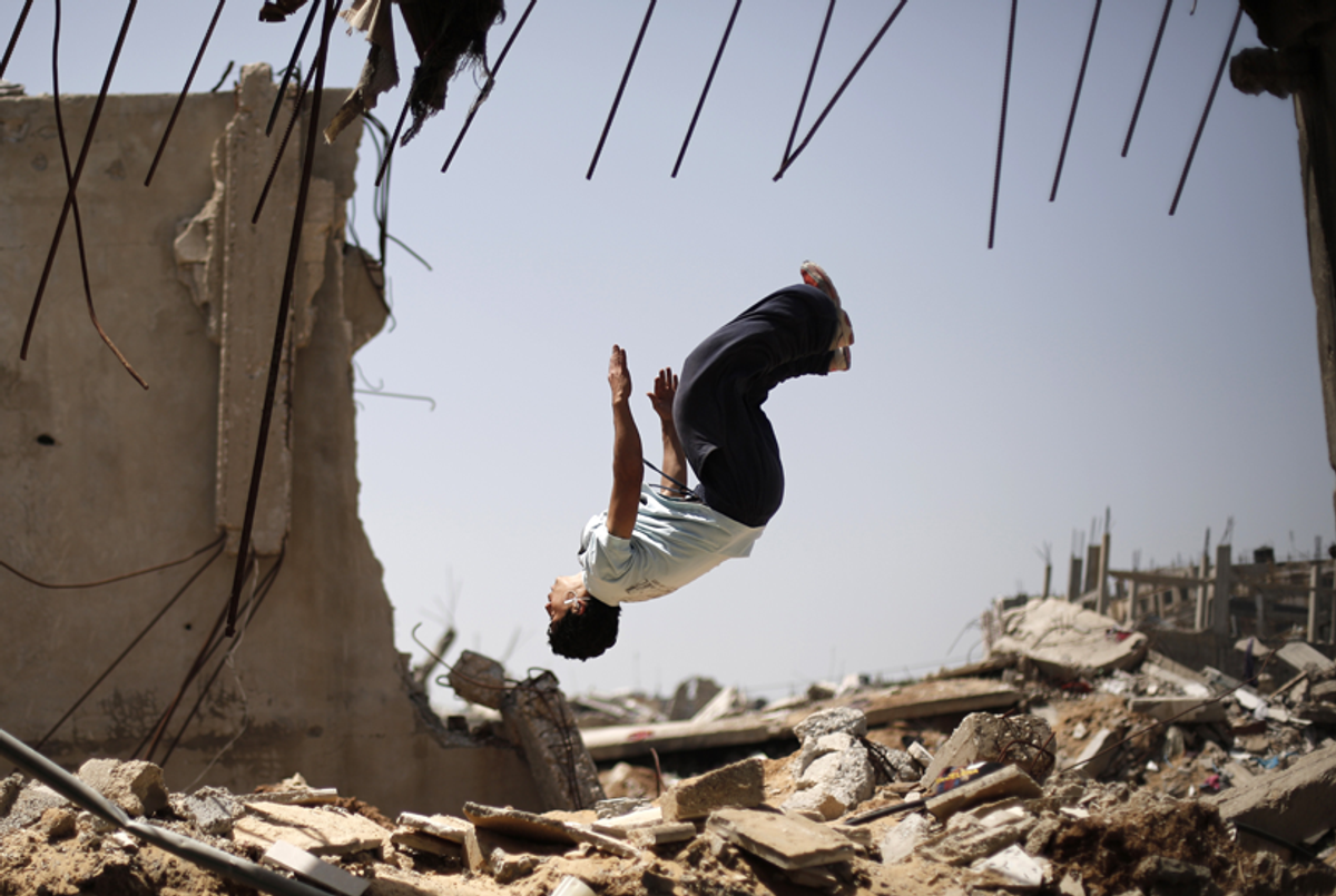 A Palestinian youth practices his Parkour skills in the ruins of buildings on April 28, 2015, in the eastern Gaza City neighborhood of Shejaiya, which was destroyed during the 50-day war between Israel and Hamas militants in the summer of 2014. (Mohammed Abed/AFP/Getty Images)