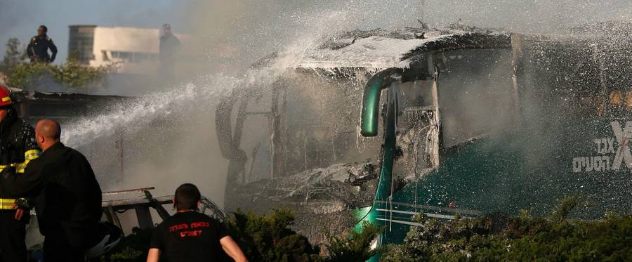 Israeli firemen extinguish a burning bus following an explosion in Jerusalem, April 18, 2016. Israel later said the explosion was caused by a suicide bombing organized by Hamas.
