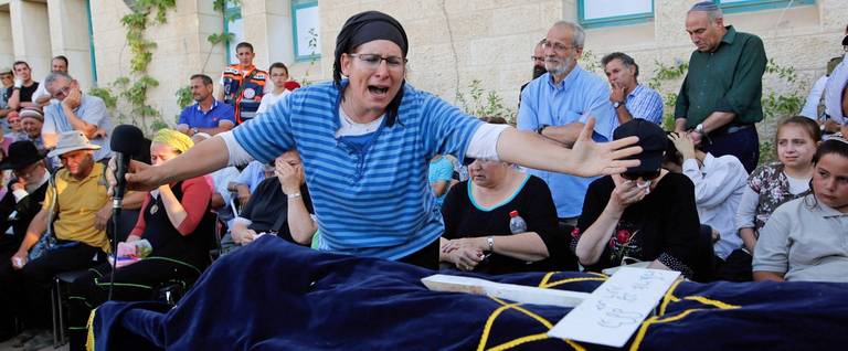 Israeli Rina Yaffa Ariel, mourns over the body of her daughter Hallel, a 13-year-old girl who was fatally stabbed by a Palestinian attacker in her home, during her funeral in the Kiryat Arba settlement outside the Israeli occupied city of Hebron on June 30, 2016.