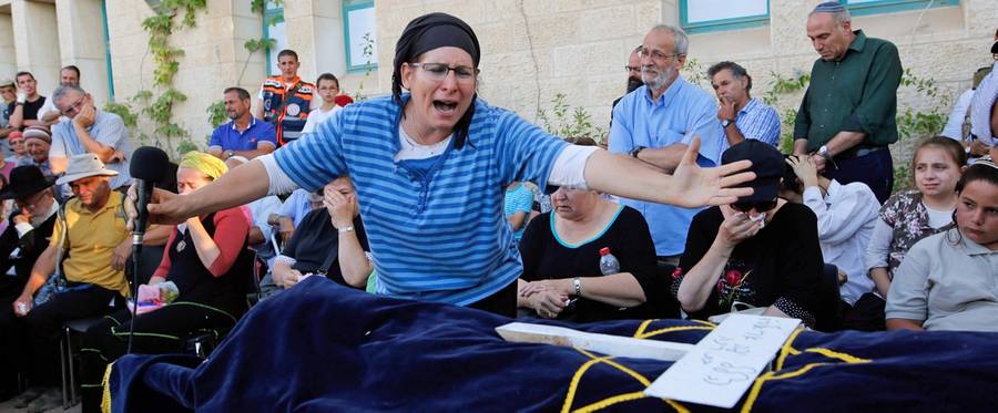 Israeli Rina Yaffa Ariel, mourns over the body of her daughter Hallel, a 13-year-old girl who was fatally stabbed by a Palestinian attacker in her home, during her funeral in the Kiryat Arba settlement outside the Israeli occupied city of Hebron on June 30, 2016.