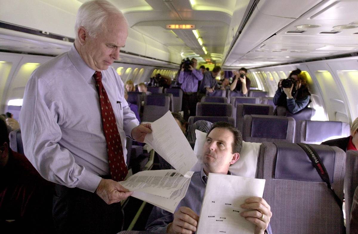 John McCain looks over some documents with John Weaver, his campaign adviser, 2000
