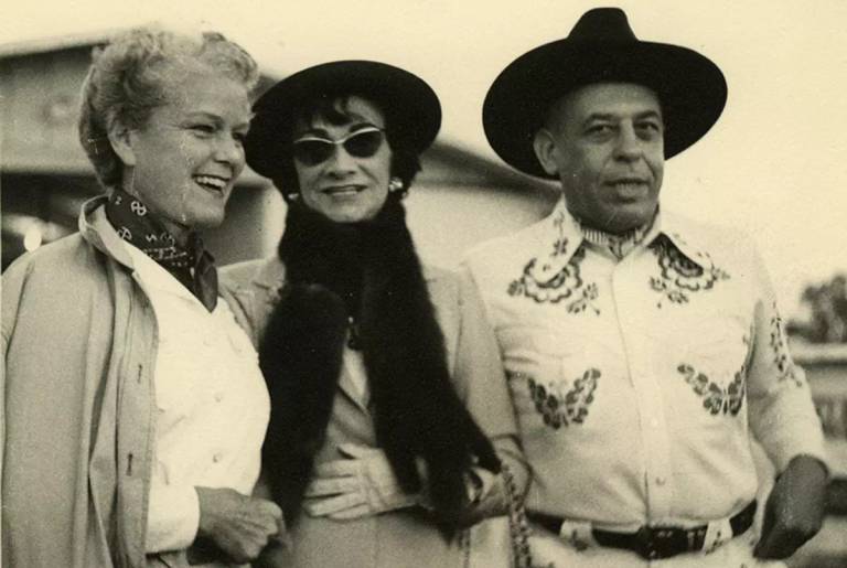 Mary 'Billie' Marcus, Gabrielle Chanel, and Stanley Marcus at the Marcus Western Party at the Black Mark Farm, Flower Mound, Texas, on Sept. 7, 1957. 