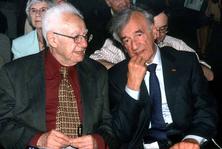 Israel Gutman and Elie Wiesel attending a conference at Auschwitz.(Yad Vashem)