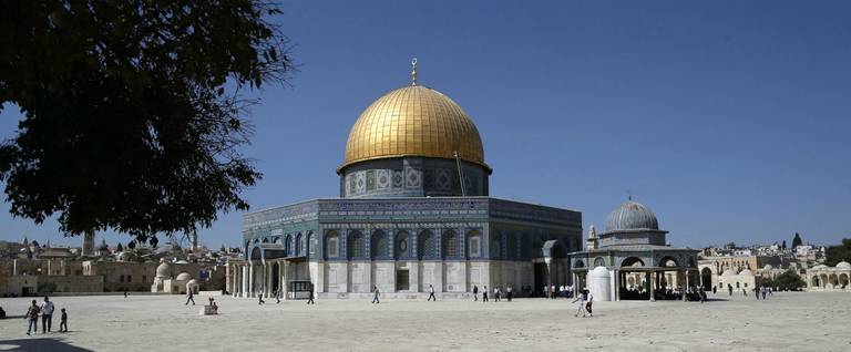Palestinians walk past the Dome of Rock at the Al-Aqsa Mosque compound before the Friday prayer in Jerusalem's Old City on October 14, 2016. (Ahmad Gharabli/AFP/Getty Images)