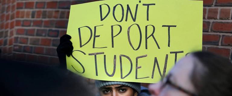 Protesters offer support to a deported Iranian student while protesting outside the federal courthouse in Boston on Jan. 21, 2020