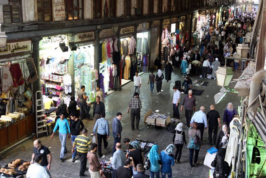 Syrians walk in the bazaar of old city of Damascus on April 10, 2012(LOUAI BESHARA/AFP/Getty Images)