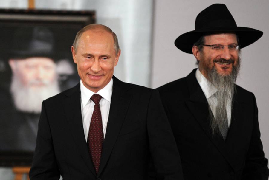 Russia's President Vladimir Putin and Russia's chief Rabbi Berel Lazar attend a ceremony at the Jewish Museum and Tolerance Centre in Moscow, on June 13, 2013. (YURI KADOBNOV/AFP/Getty Images)