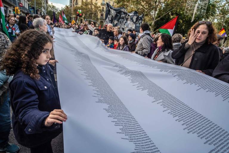 Protesters in Barcelona carry a banner listing names of Palestinian casualties in Gaza, Nov. 11, 2023