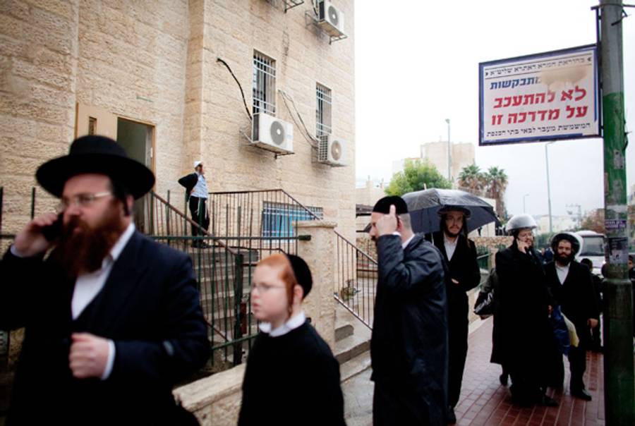 Beit Shemesh on Sunday. The sign asks women to cross the street.(Uriel Sinai/Getty Images)