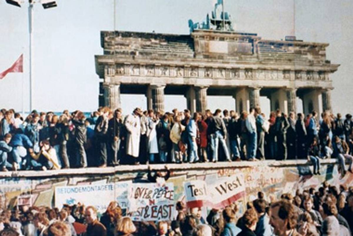 Germans celebrating on the Berlin Wall, 1989.(Wikimedia Commons)