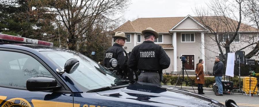 New York State Troopers stand guard in front of the house of Rabbi Chaim Rottenberg on Dec. 29, 2019, in Monsey, New York. Five people were injured in a knife attack during a Hanukkah party, and a suspect, identified as Grafton E. Thomas, was later arrested in Harlem.