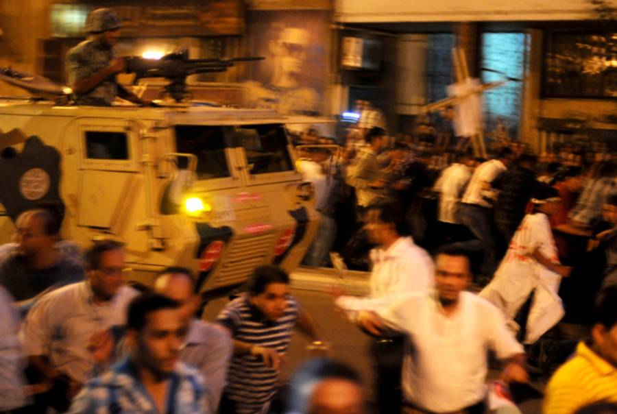 Coptic Christian protesters flee police yesterday.(Mohammed Hossam/AFP/Getty Images)