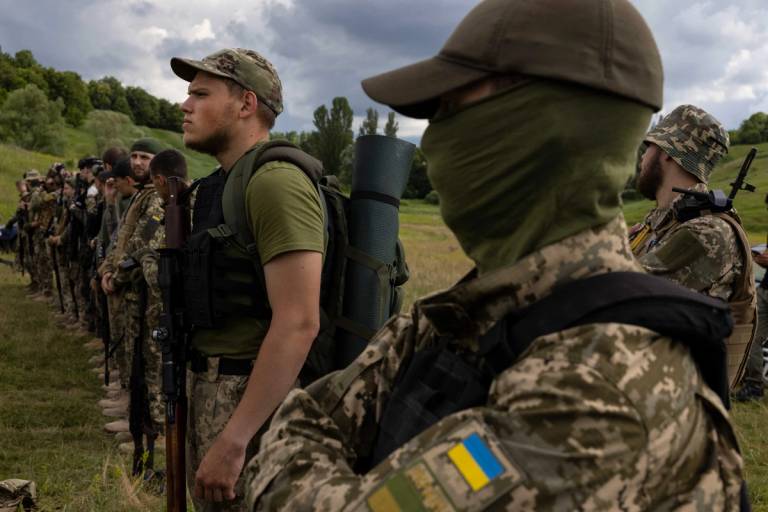 Azov Regiment soldiers line up for instruction during target practice in the Kharkiv region of Ukraine on June 23, 2022 
