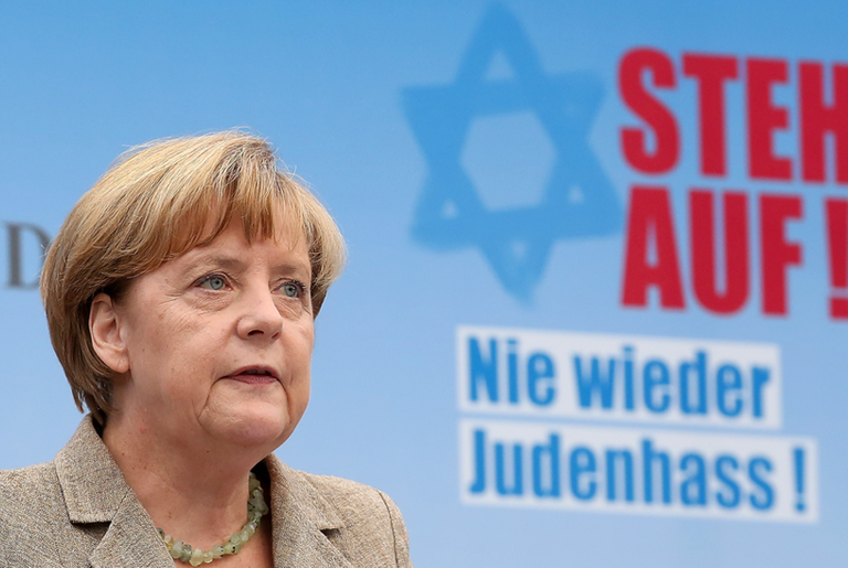 German Chancellor Angela Merkel speaks at a rally against anti-Semitism on September 14, 2014, in Berlin. The slogan behind her reads 'Stand Up! Never Again Hatred Toward Jews'.(Adam Berry/Getty Images)