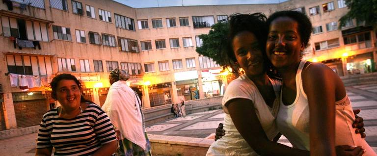 Ethiopian Jewish teenage girls, both born in Israel, with their Israeli friend (L) in the local shopping plaza in the neighborhood where their families settled a few years ago, on July 2, 2007 in Netanya, central Israel. Some 2,500 Ethiopians of Jewish origin remain in the East African country as Israel slowly brings them over, a few dozen at a time, on commercial flights. Since 1984, more than 73,000 Ethiopian Jews have been settled in Israel. 