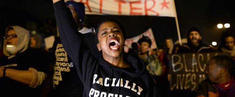 Demonstrators shout slogans during a march in St. Louis, Missouri, on November 23, 2014 to protest the death of 18-year-old Michael Brown. 
