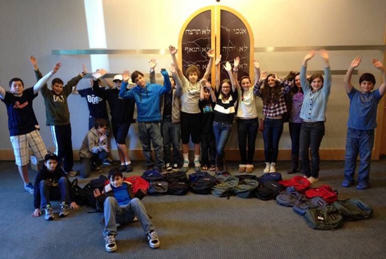 Congregation Micah 2012/2013 seventh-graders literally “Fill the Backpacks” with school supplies for kids connected with JFS and YES programs.(Rachel Tawil Kenyon)