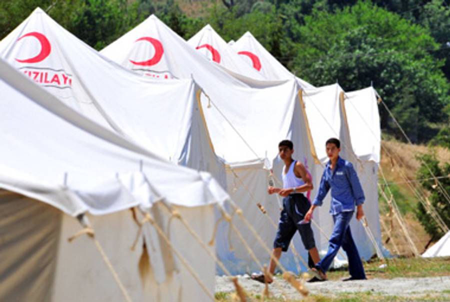 Syrian refugees just inside Turkey.(Mustafa Ozer/AFP/Getty Image)