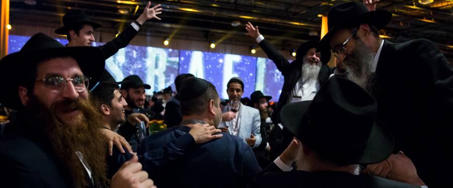 Hassidic rabbis and guests from around the world dance during the Chabad-Lubavitch annual dinner on November 19, 2017.