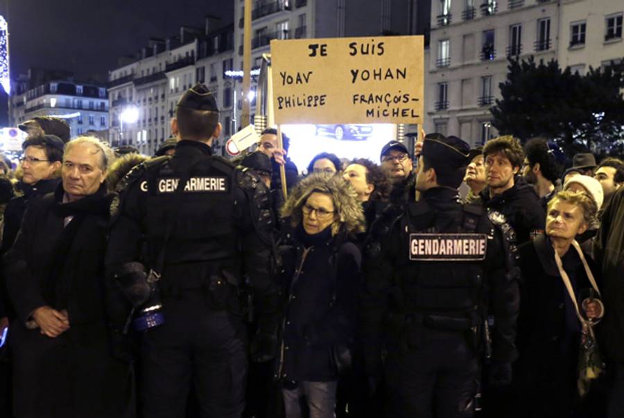 A woman holds a placard reading: 'I am Yoav, Philippe, Yohan, Francois-Michel', the first names of the victims of the January 9 siege on a kosher supermarket. (KENZO TRIBOUILLARD/AFP/Getty Images)