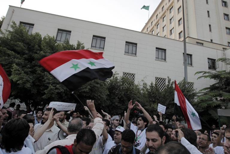 Syrians protest against President Assad last week outside an Arab League meeting in Cairo.(Mahmud Hams/AFP/Getty Images)