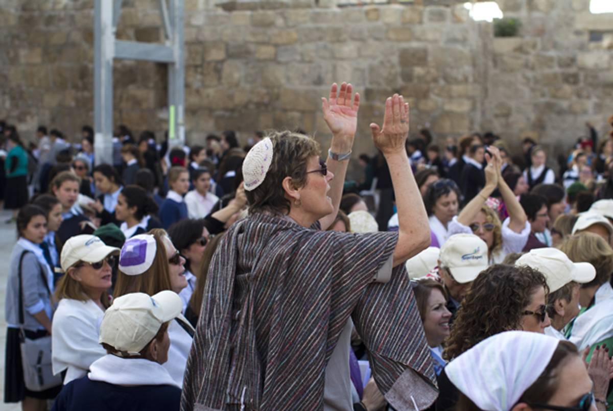 Israeli women, some wearing prayer shawls, pray at the Western Wall in Jerusalem on November 4, 2013. (AHMAD GHARABLI/AFP/Getty Images)