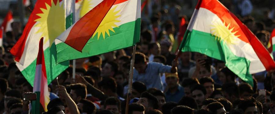 Iraqi Kurds gather in the street flying Kurdish flags as they urge people to vote in the upcoming independence referendum in Arbil, the capital of the autonomous Kurdish region of northern Iraq, on September 13, 2017. Iraq's autonomous Kurdish region will hold a historic referendum on statehood in September 2017, despite opposition to independence from Baghdad and possibly beyond.