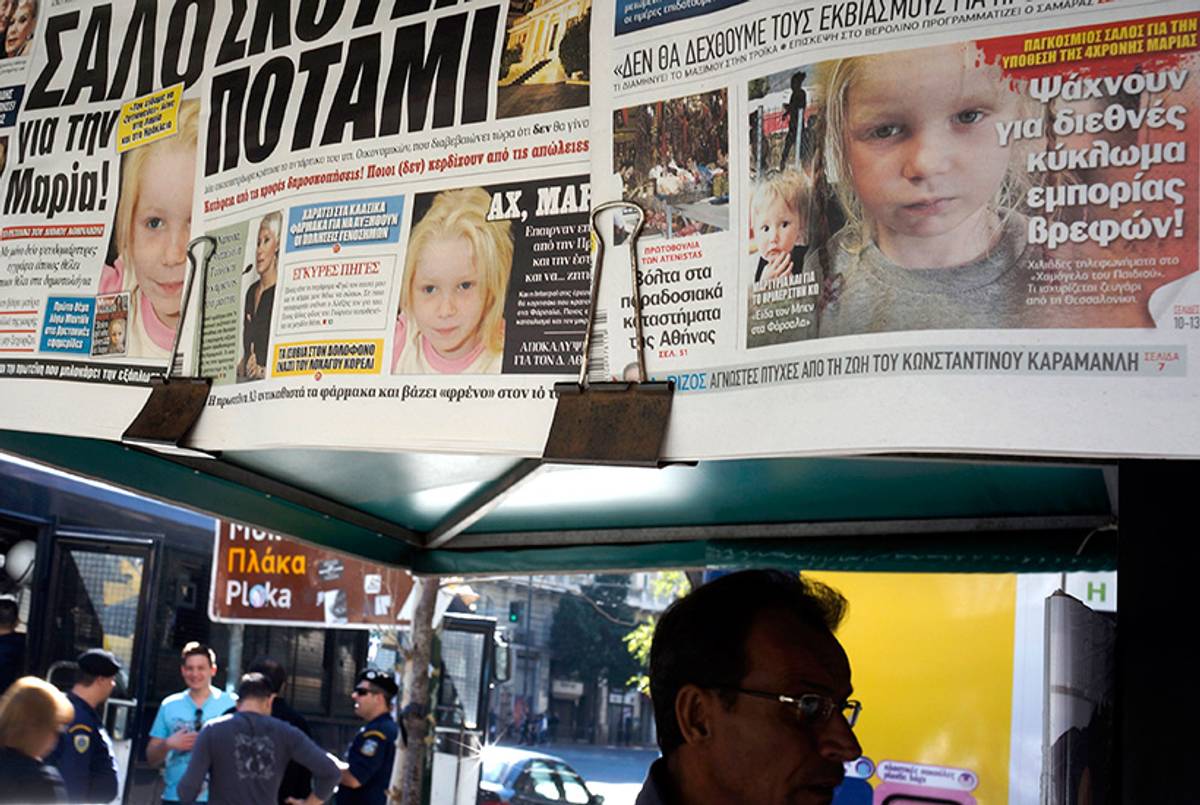People in Athens walk past newspapers reporting on the story a 4-year-old girl reportedly named Maria, who was found living with a Roma couple in central Greece, on October 21, 2013.(Milos Bicanski/Getty Images)