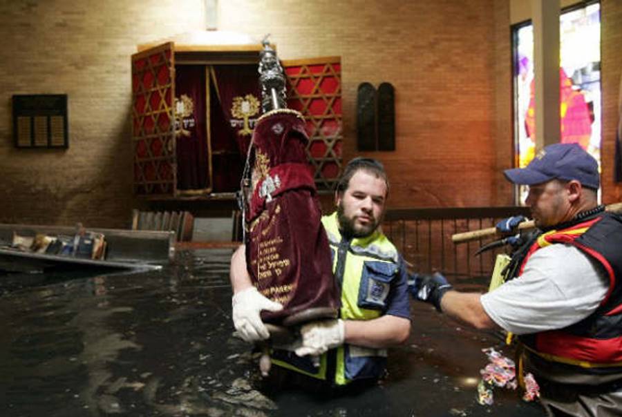 Removing Torah scrolls from New Orleans' flooded Beth Israel Synagogue following Hurricane Katrina.(Alan Smason)
