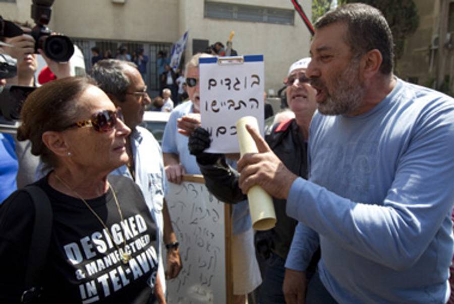 Today in Tel Aviv, a right-wing protester (R) argues with a left-wing one (L) who also happens to be the daughter of Moshe Dayan.(Jack Guez/AFP/Getty Images))