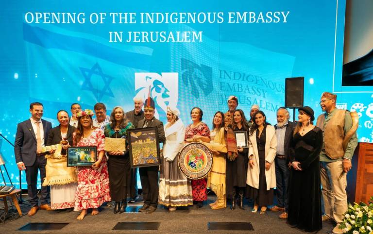 The authors, center, in the feathered headdress and white hat, at the opening of the Indigenous Embassy in Jerusalem on Feb. 1, 2024
