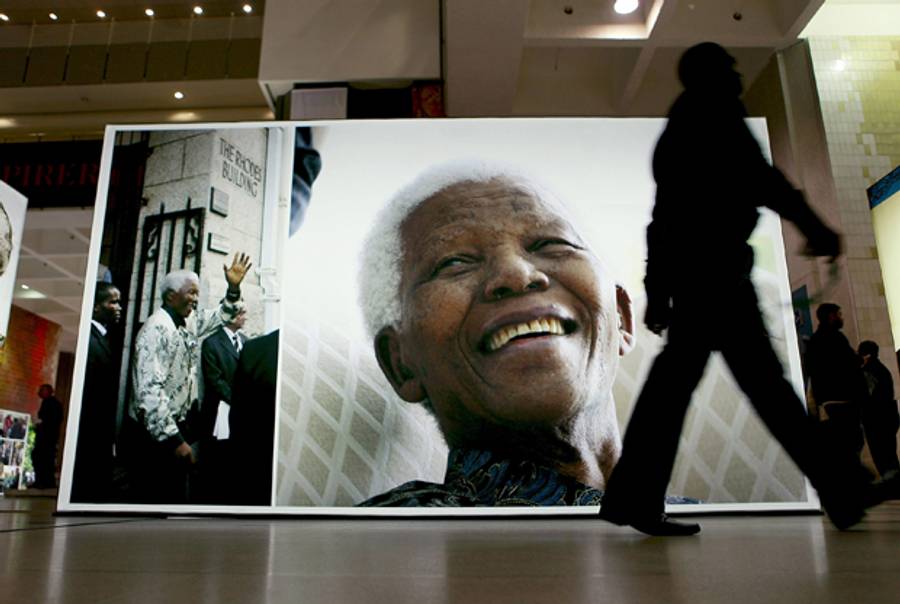 A person walk past a display at the Cape Town Honours Nelson Mandela exhibition at the Cape Town Civic Centre as part of the Cape Town Honours Nelson Mandela exhibition on June 27, 2013 in Cape Town, South Africa.(Michelly Rall/Getty Images)