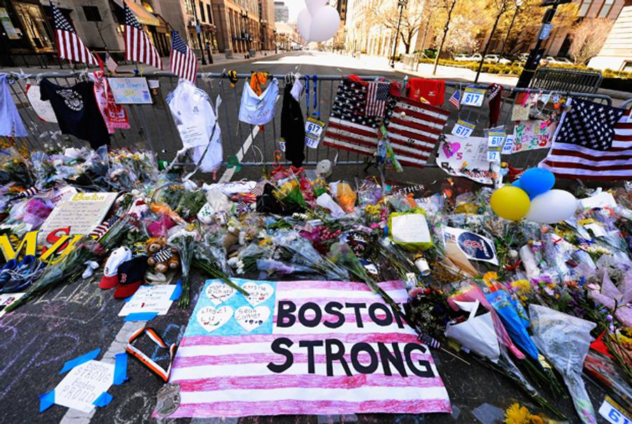 Items are placed by people visiting a makeshift memorial for victims near the site of the Boston Marathon bombings at the intersection of Boylston Street and Berkley Street on April 21, 2013 in Boston, Massachusetts.(Kevork Djansezian/Getty Images)