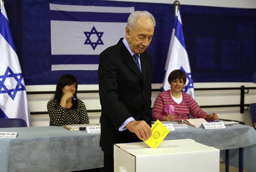 Israeli President Shimon Peres casts his vote for the municipality elections at a polling station in Jerusalem on October 22, 2013. (GALI TIBBON/AFP/Getty Images)