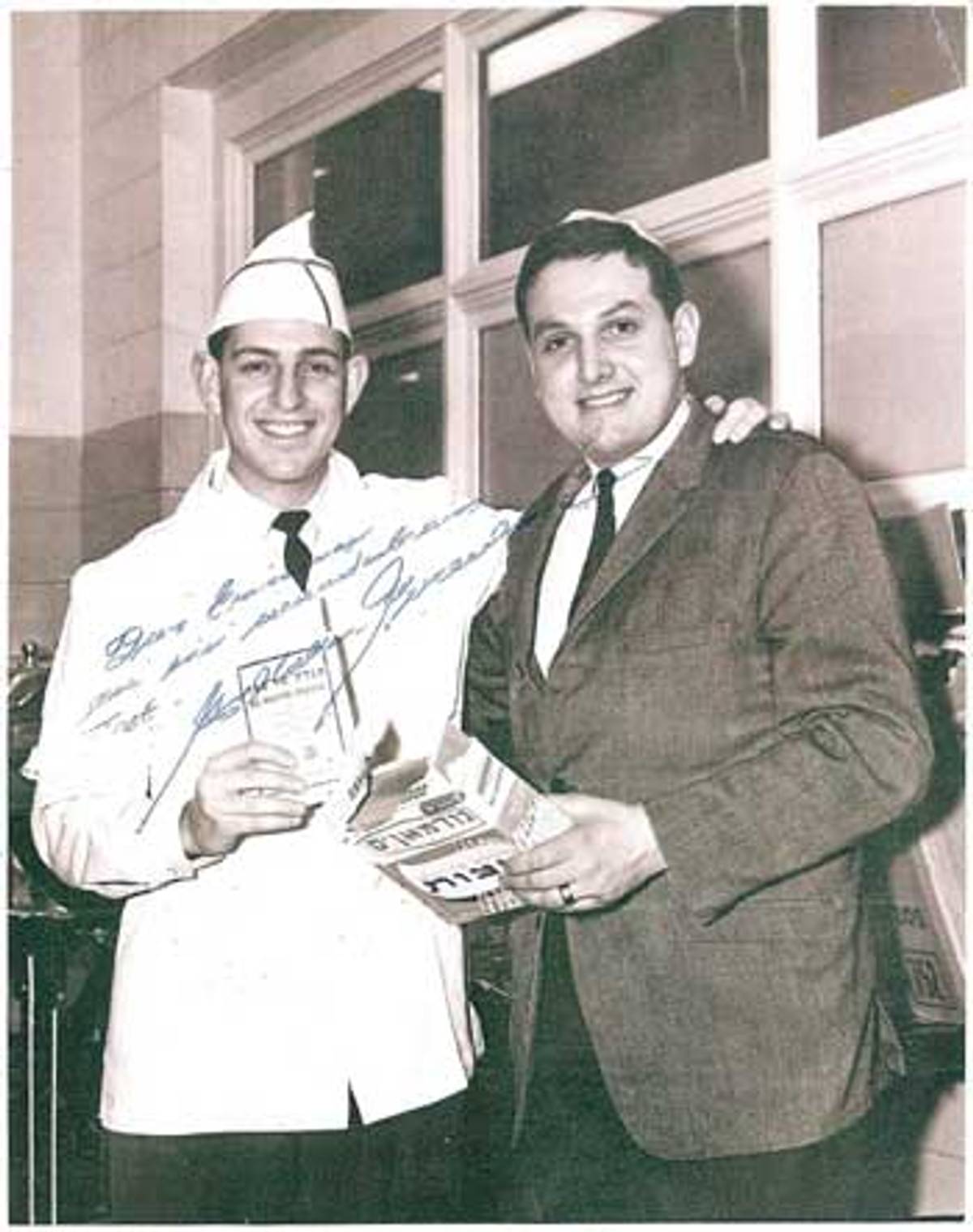 Rabbi Schwartz (left) hands out matzo in 1967. (Photo courtesy Rabbi Barry Dov Schwartz)