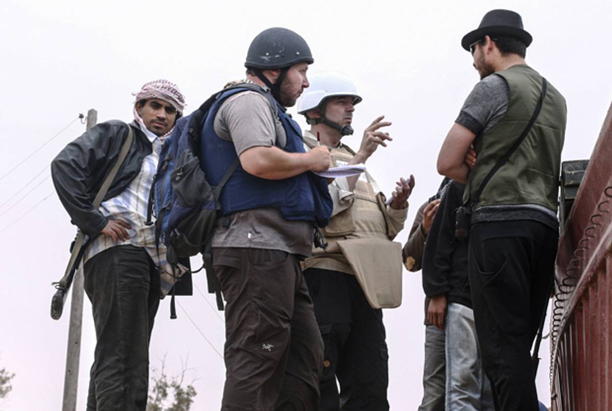 In this handout image made available by the photographer American journalist Steven Sotloff (Center with black helmet) talks to Libyan rebels on the Al Dafniya front line in Misrata, Libya on June 02, 2011. Sotloff was kidnapped in August 2013 near Aleppo, Syria. (Etienne de Malglaive via Getty Images)