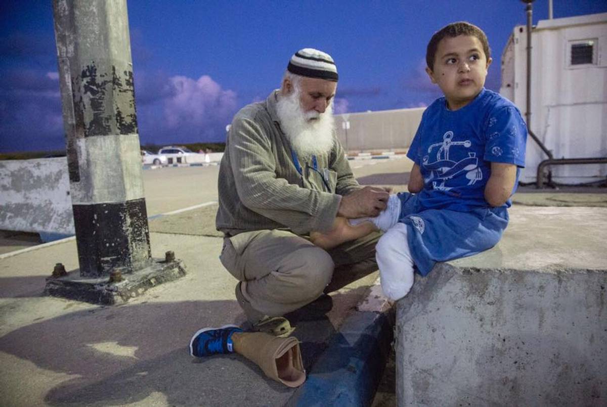 Muhi with his grandfather at the Erez Crossing. Facebook