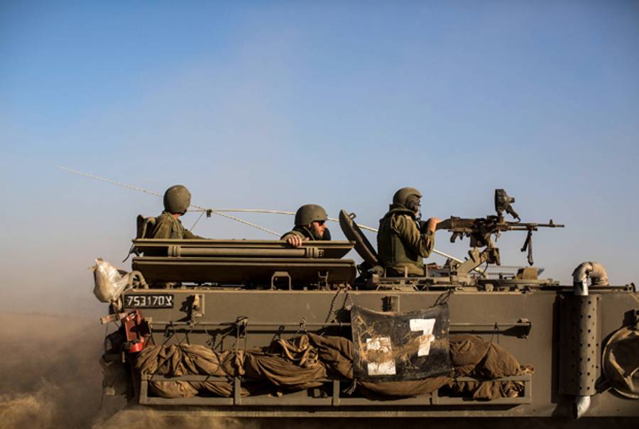 Israeli armored personnel carrier seen moving along the border with Gaza on July 10, 2014 on Israel's border with the Gaza Strip. (Ilia Yefimovich/Getty Images)
