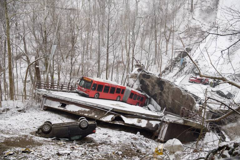 Vehicles including a Port Authority bus are left stranded after a bridge collapsed along Forbes Avenue in Pittsburgh on Jan. 28, 2022