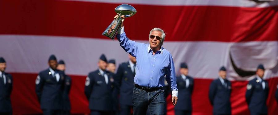 New England Patriots owner Robert Kraft enters Fenway Park holding the Vince Lombardi trophy before the game between the Washington Nationals and the Boston Red Sox on April 13, 2015 in Boston, Massachusetts.