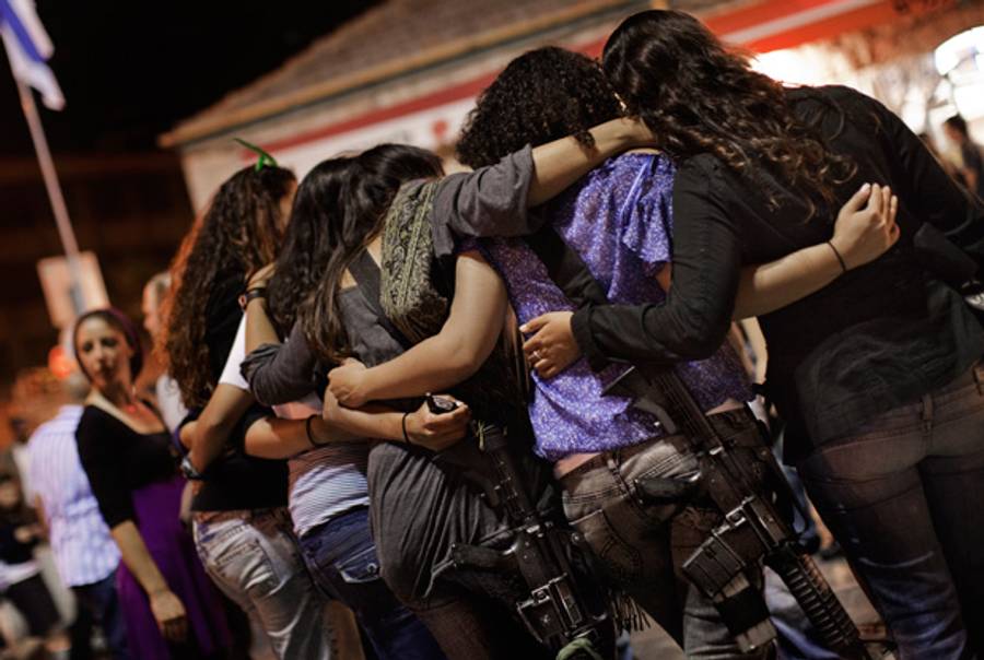 Israeli girls wear automatic rifles as they dance together during the celebrations for Independence Day in Jerusalem on April 19, 2010.(Marco Longari/AFP/Getty Images)
