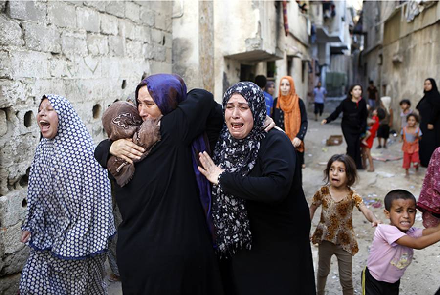 Palestinian women grieve during the funerals of four boys killed during Israeli air strikes in Gaza City on July 16, 2014.(MOHAMMED ABED/AFP/Getty Images)