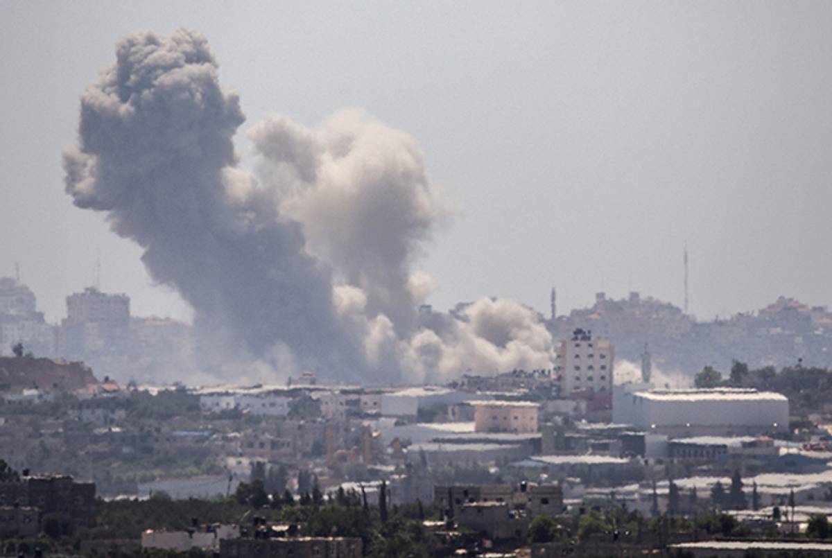 A picture taken from the southern Israeli-Gaza Strip border shows an explosion moments after an Israeli air strike on Gaza City, on July 11, 2014. (JACK GUEZ/AFP/Getty Images)