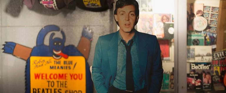 A cardboard cutout of Paul McCartney from The Beatles is on sale with other memorabilia and merchandise in a shop on Feb. 11, 2016, in Liverpool, England.