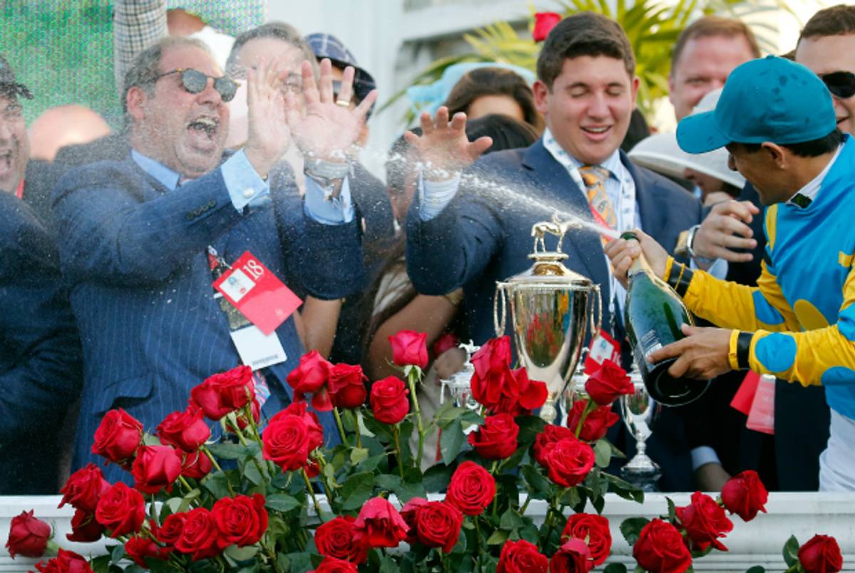 Ahmed Zayat is sprayed by Jockey Victor Espinoza at the Kentucky Derby at Churchill Downs on May 2, 2015. (Rob Carr/Getty Images)