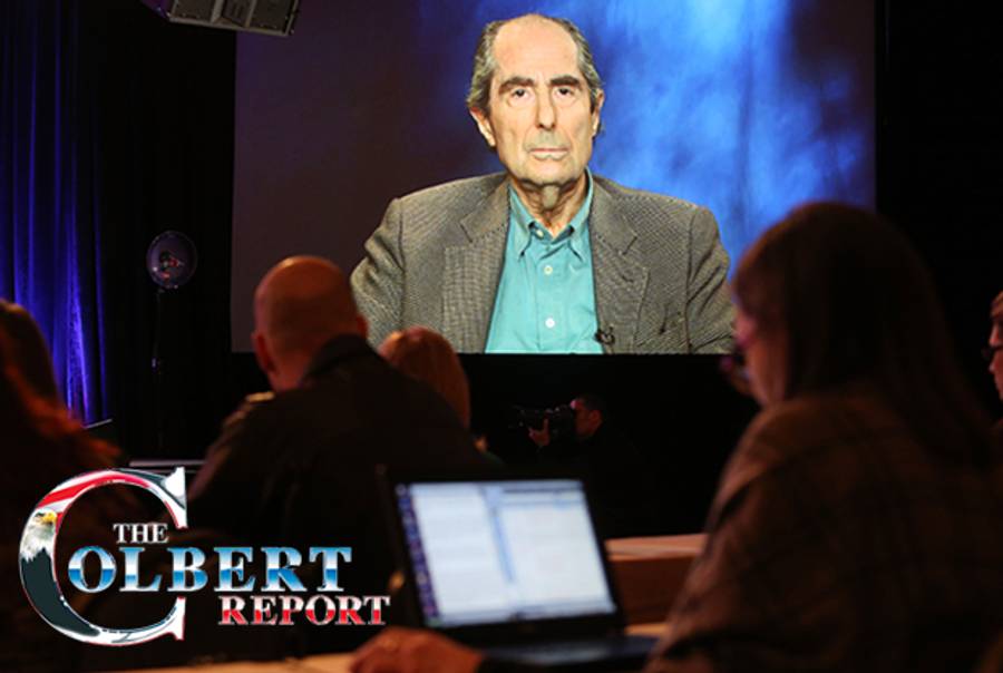 Philip Roth. (Photocollage, Tablet Magazine; Roth: Photo by Frederick M. Brown/Getty Images; Colbert Report logo: Comedy Central)